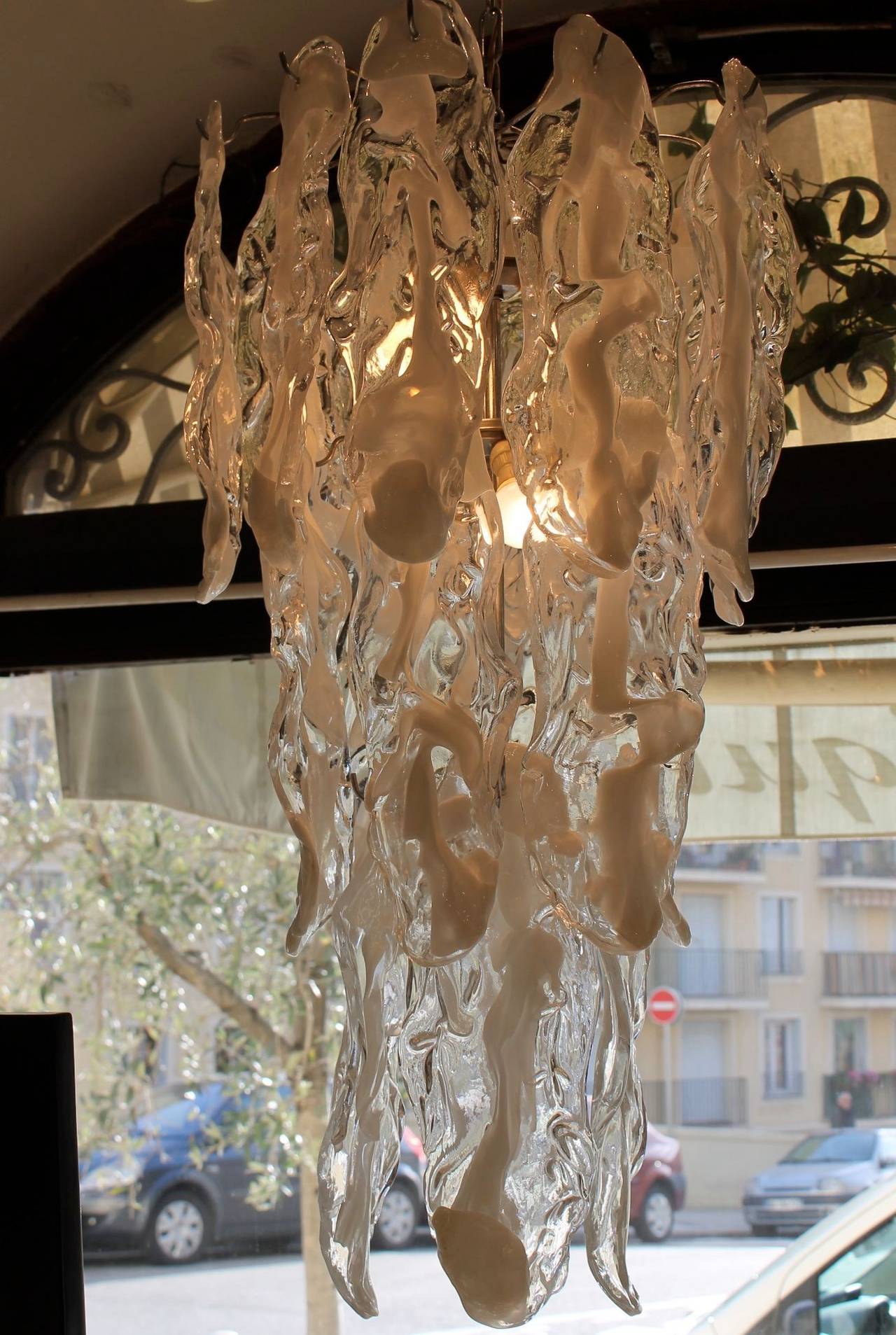 Very nice chandelier by Murano Mazzega, with glass leaves. High quality glass lamp with nice light effect.