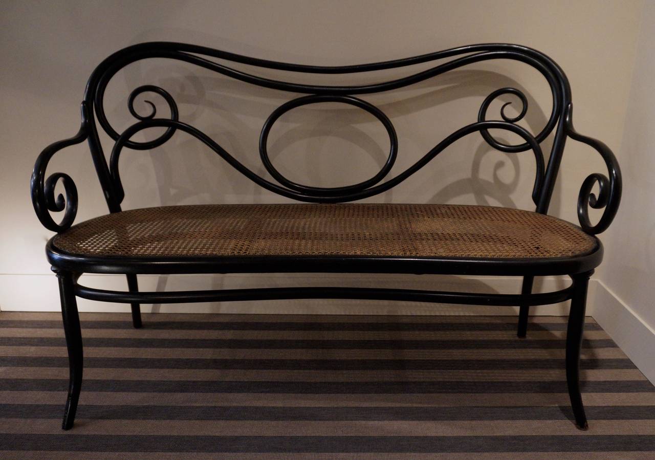 Ebonised steamed beech with cane seat. Original condition.