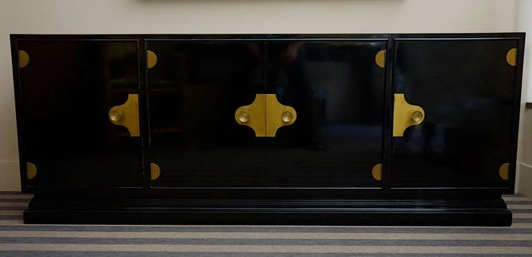 Four doors. Gilt bronze handles. Placed on a molded base. Shelves.