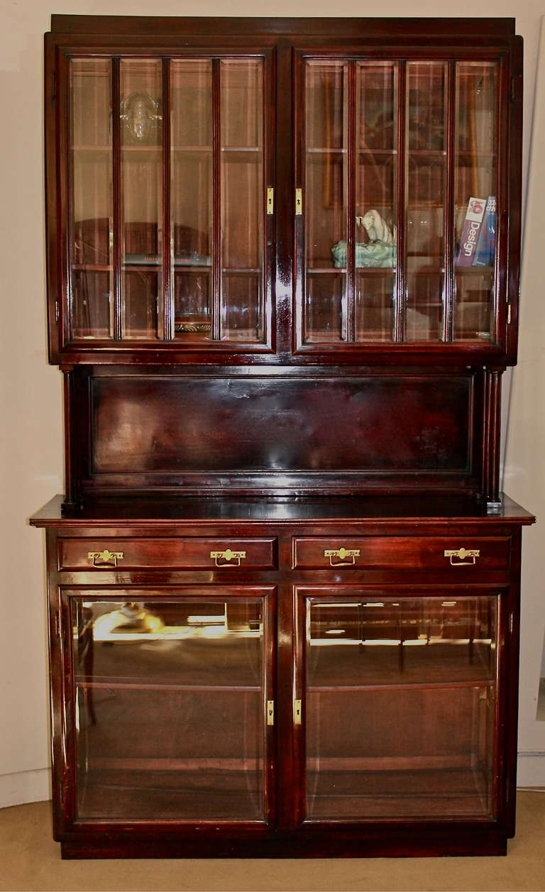 Viennese large double bodied vitrine or cupboard. Four doors and two drawers. Beveled glass on the first part of the sideboard. Mahogany tainted beech tree. Is in its original condition and needs a few restoration.