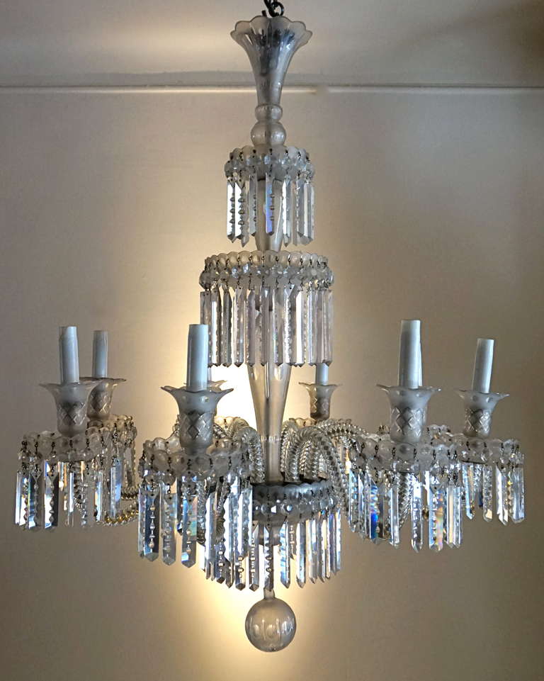 A large cut crystal chandelier with eight lights.