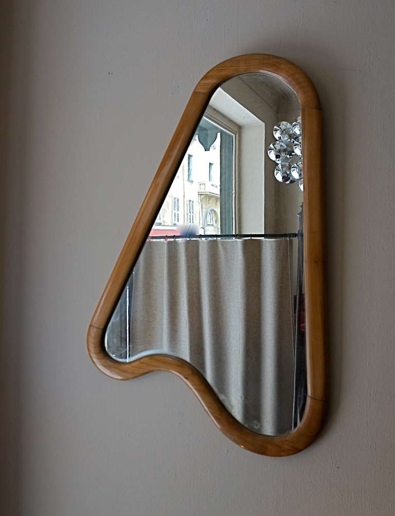 A wooden frame mirror. Undulating form.
Pear tree. Mirroring glass.