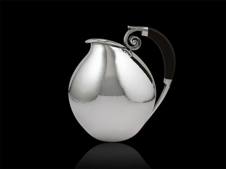 Sterling silver water pitcher with ebony handle, design #653 by Johan Rohde.
Measures 7 1/4