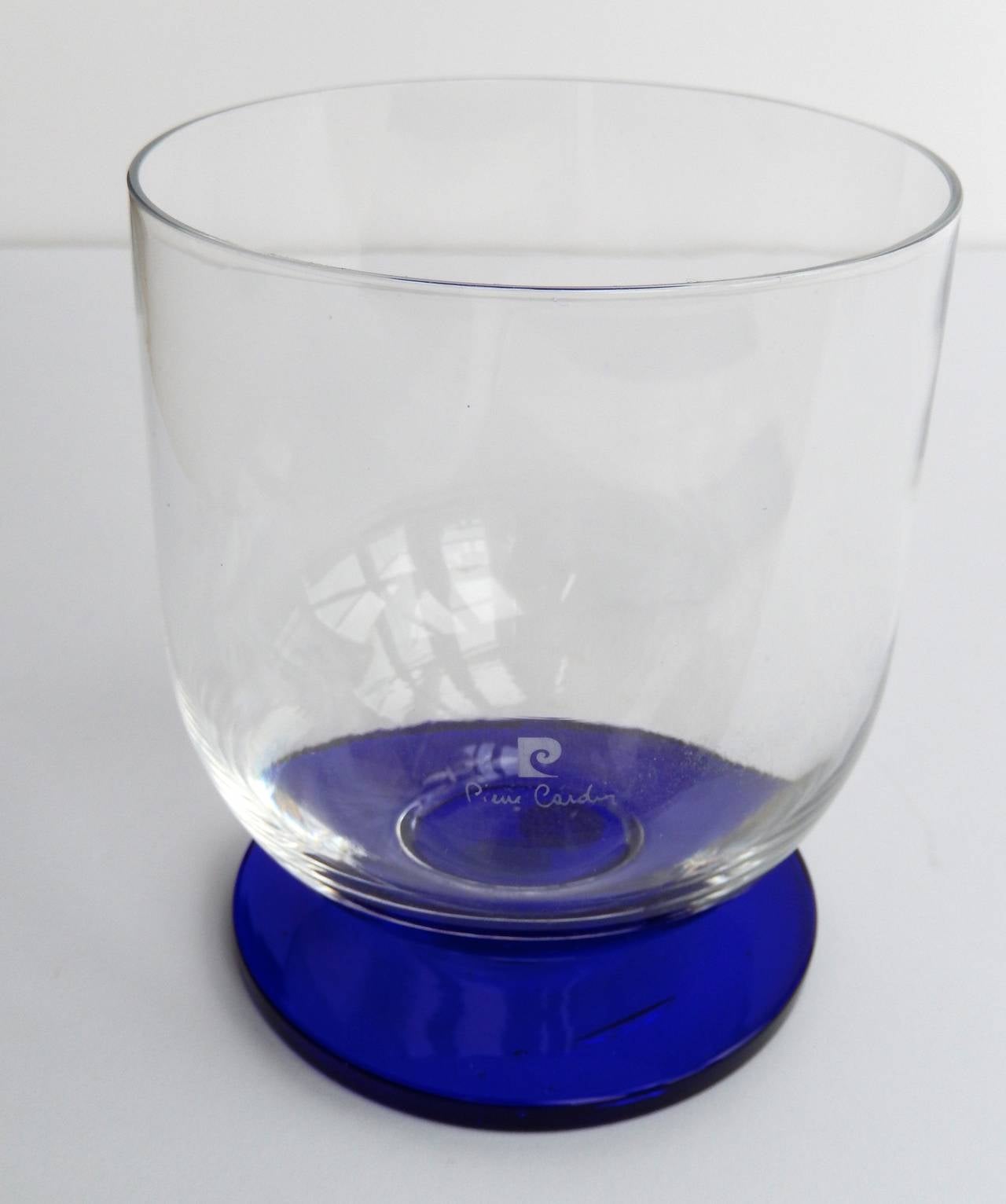 A rare 1970s ice bucket by Pierre Cardin with a modernist design. The combination of a clear glass bowl with a beautiful French blue glass base is striking. Etched signature and logo. 

Reference: See p. 192 in Pierre Cardin Evolution by Benjamin