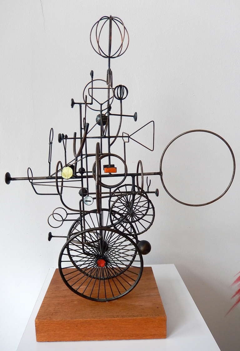 A whimsical welded steel and enamel construction by Chicago sculptor
Joseph Burlini (b. 1937). Though his training was in industrial design, Burlini turned to fine art and created a large body of elaborate constructions he called 