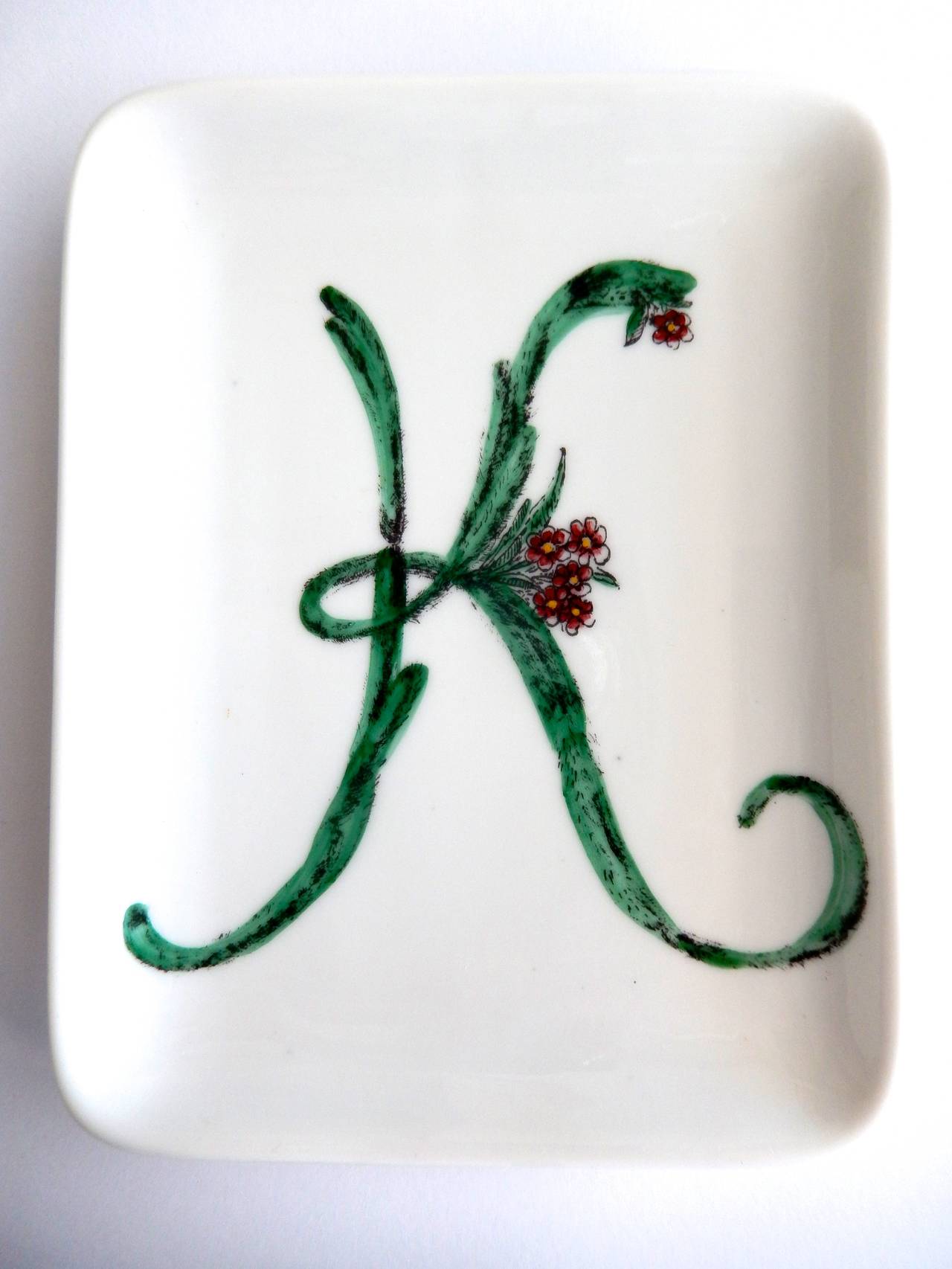 An unusual ceramic dish or pin tray by Fornasetti with a stylized cactus flower design forming the letter 