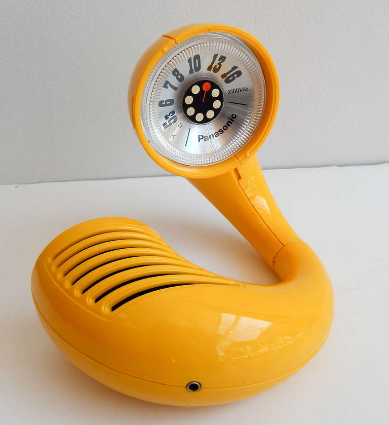 A bright yellow Toot-A-Loop AM radio by Panasonic in exceptionally nice condition. This battery-powered wrist radio is doughnut-shaped and when twisted open, reveals the dial inside.  Great, witty 1960s design.  In good working condition and