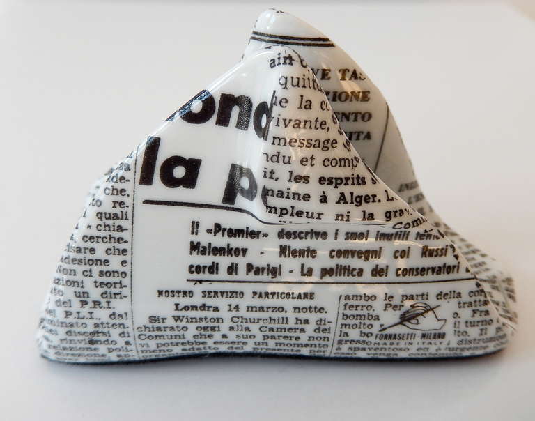 Cleverly designed cardholder by Piero Fornasetti shaped to resemble a folded newspaper. Newsprint is in Italian and Russian. Fornasetti mark incorporated into the text.