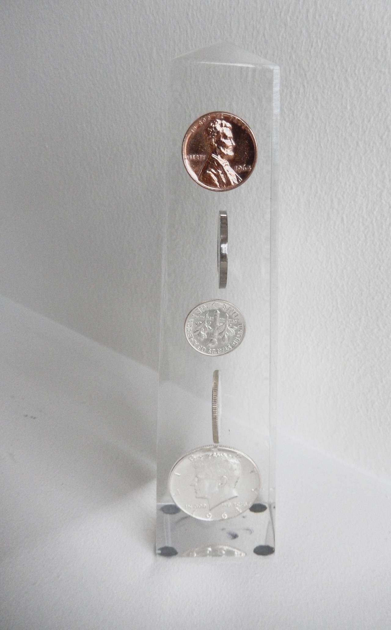 A lucite obelisk with suspended coins dating from 1964.  Possibly created to commemorate the year in which the Civil Rights Act was signed into law by President Lyndon Johnson.