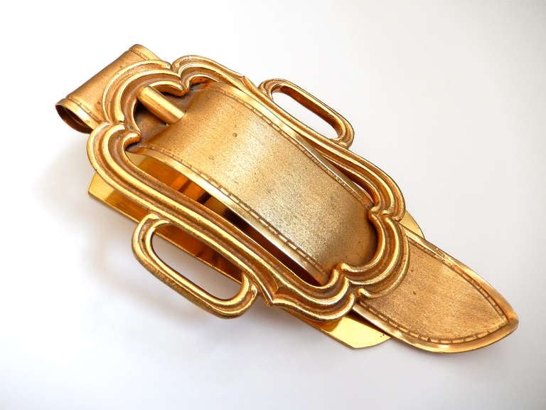 A large gilt metal clip, with a classical buckle design, to hold stationery or other papers.  Made in Italy for Saks Fifth Avenue. An elegant and unusual desk accessory. Perfect to hold love letters.