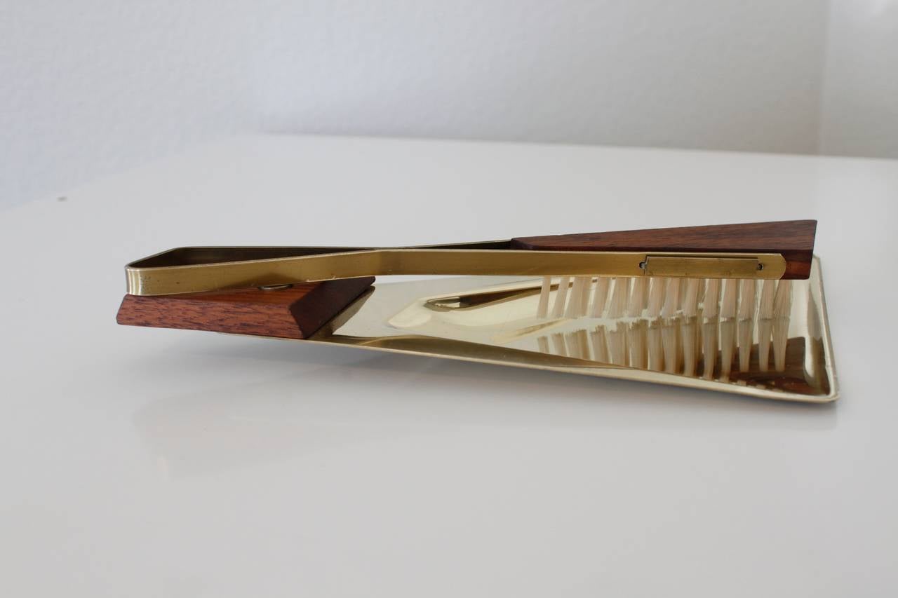 Architectural Mid-Century brass and walnut table butler brush and crumb pan from West Germany. Brass is in very nice condition, normal wear on the underside. Stamped and numbered Western Germany.