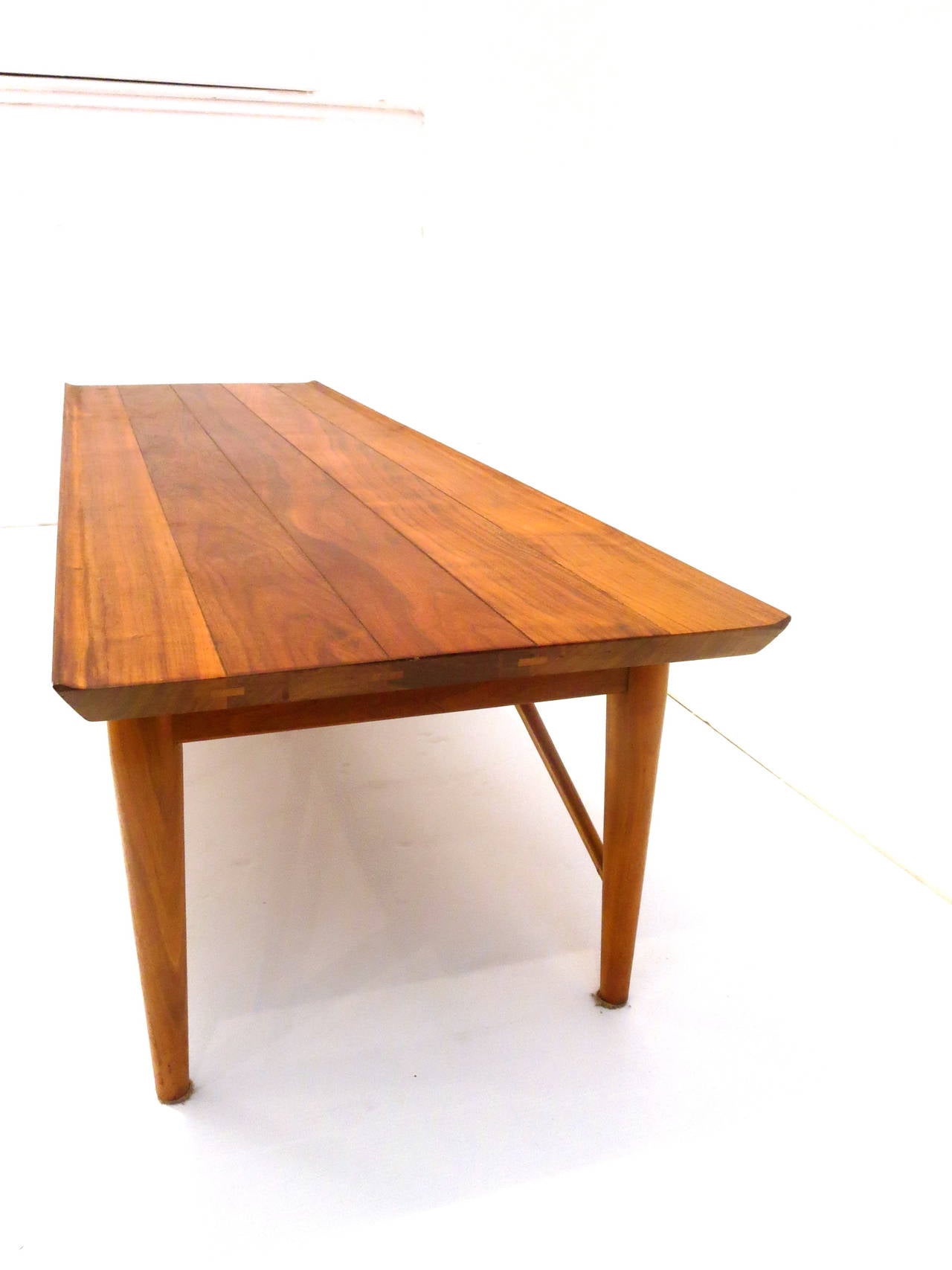 Beautiful craftsmanship on this solid walnut coffee table in the style of Nakashima, circa 1960s made by Heritage completely restored and refinished great condition raised edge and dove tail ends with pull drawer.