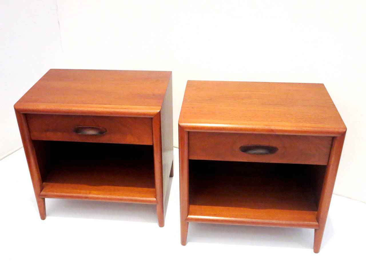 Great set of nightstands in mahogany wood with single drawer and bottom shelf freshly refinished attributed to T.H. Robsjohn-Gibbings for Widdicomb retains its label.