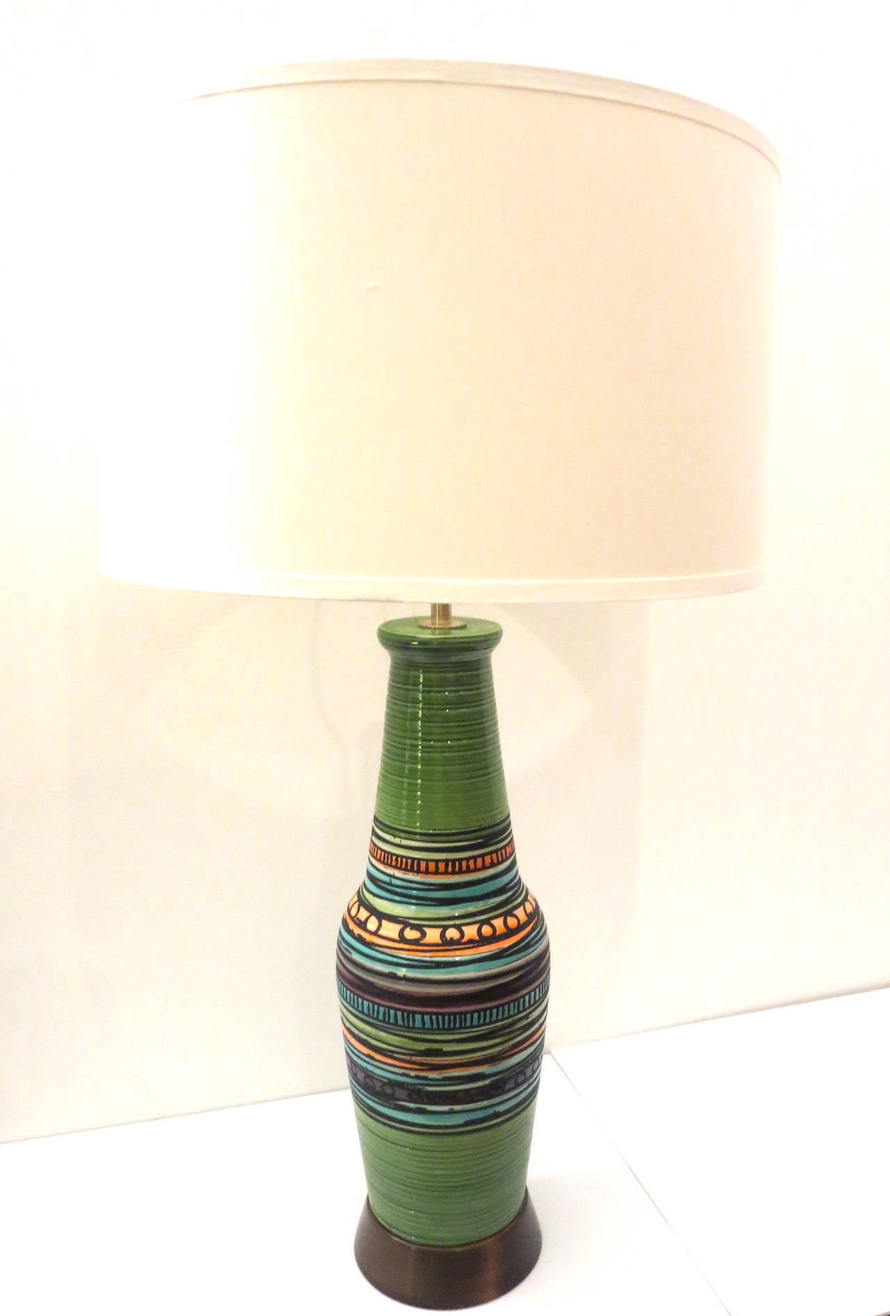 Striking tall colorfull table ceramic base, Made in Italy circa 50s hand painted nice condition sitting on a solid walnut base with polished brass fittings ,I have cleaned and opened the lamp for cleanning its rewired no chips or cracks and in