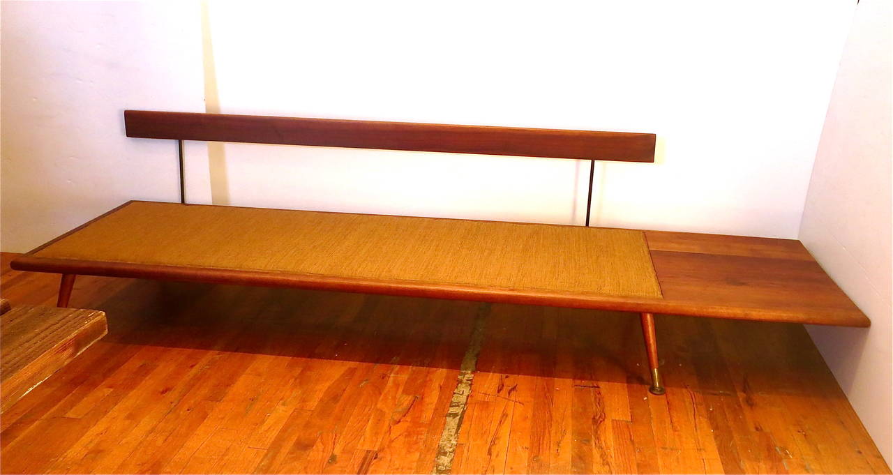 Striking solid walnut frame sofa or daybed, with attached side table, removable back cushion converts in daybed, freshly recover in orange/brown fabric and new foam cushions the walnut base its been refinished and restored one of a kind piece. With