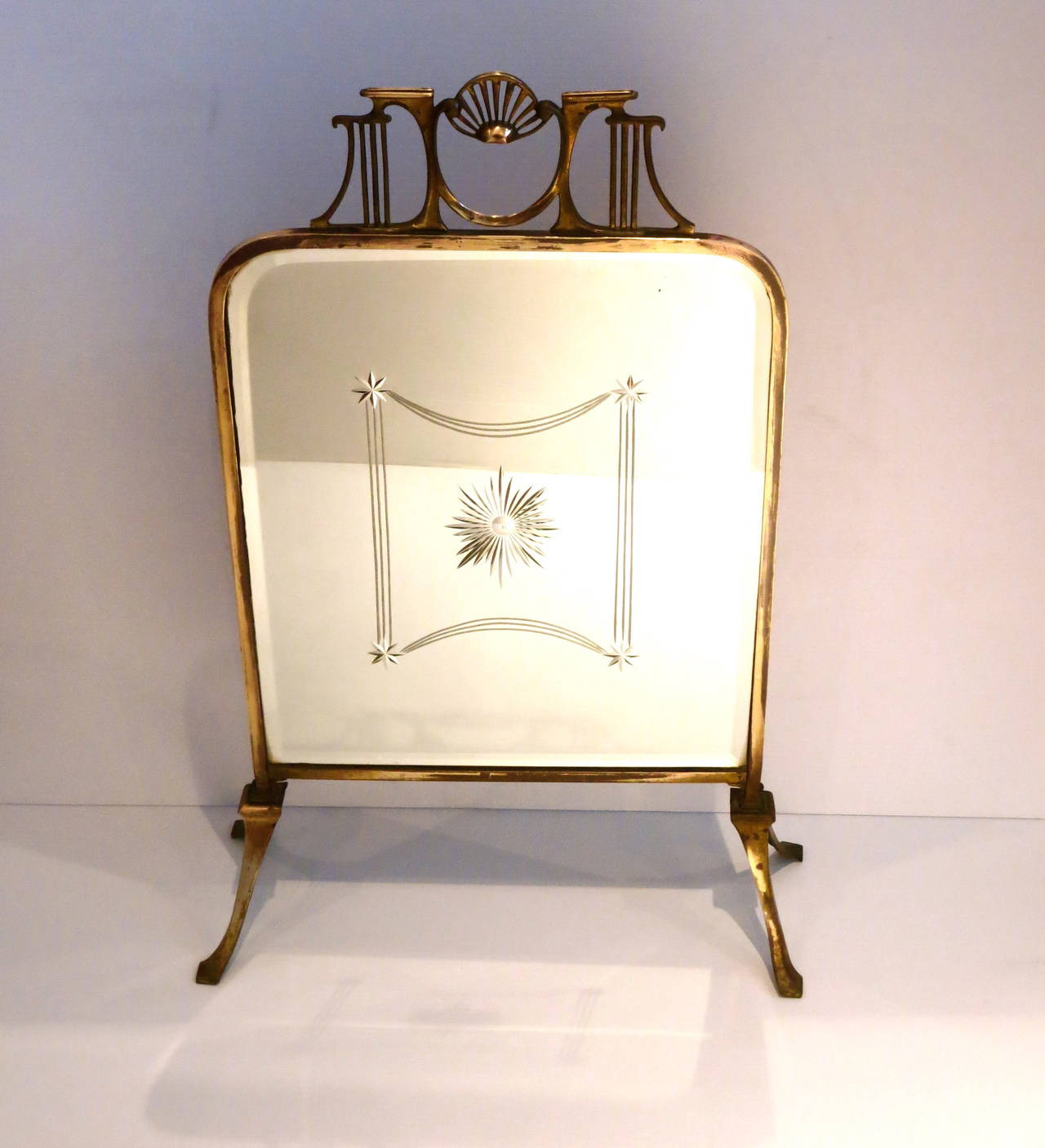 A beautiful aged brass free standing fire screen, the antique silver plated mirror with great design, and Art Nouveau piece hard to find, the brass can be polished to mirror shine, also the legs can be removed and be used like a wall mirror.