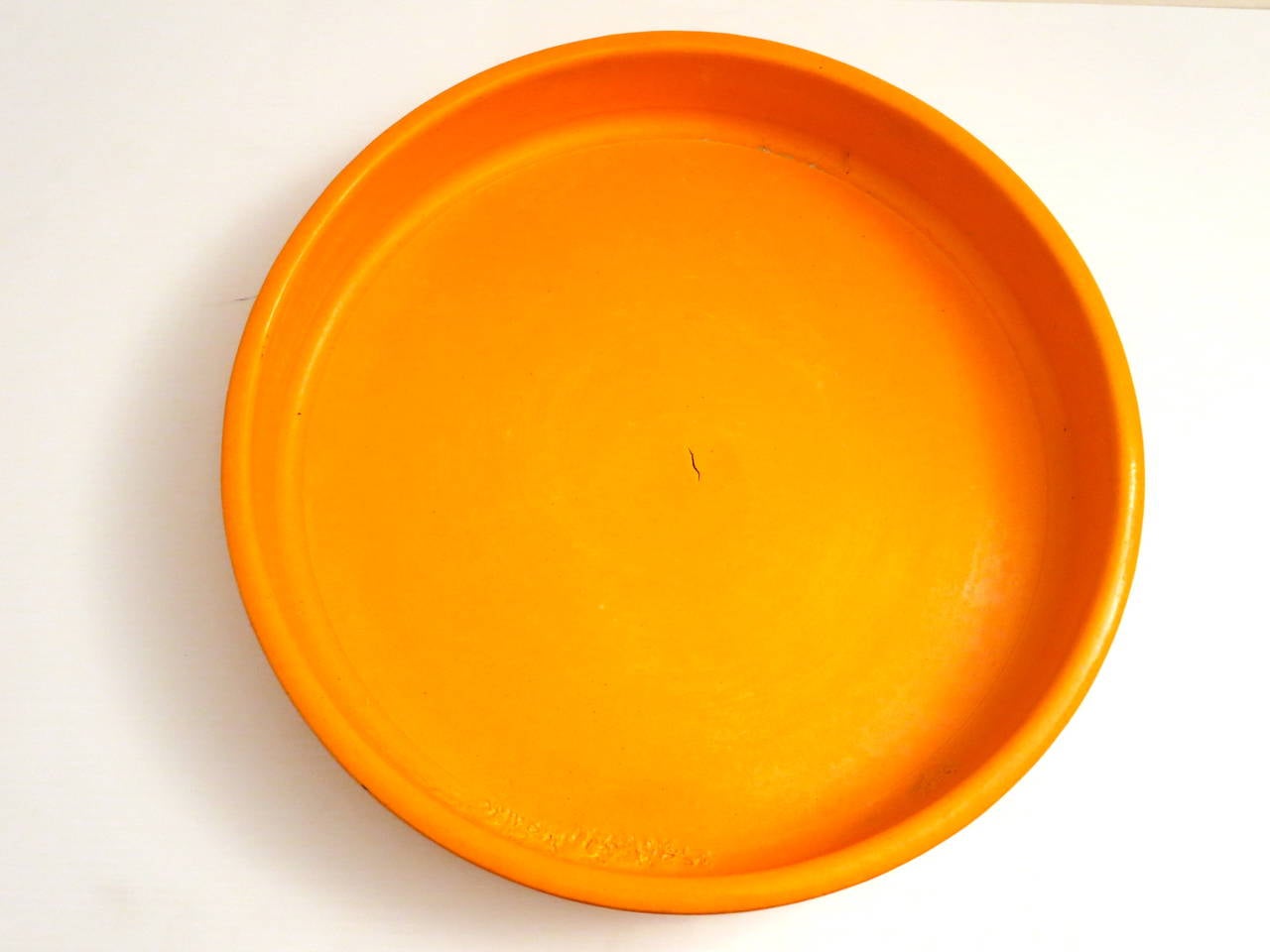 Beautiful low round planter by John Follis for Architectural Pottery in delicious orange glaze circa 1960s, in nice condition no chips a factory crack as shown, on the picture bottom.