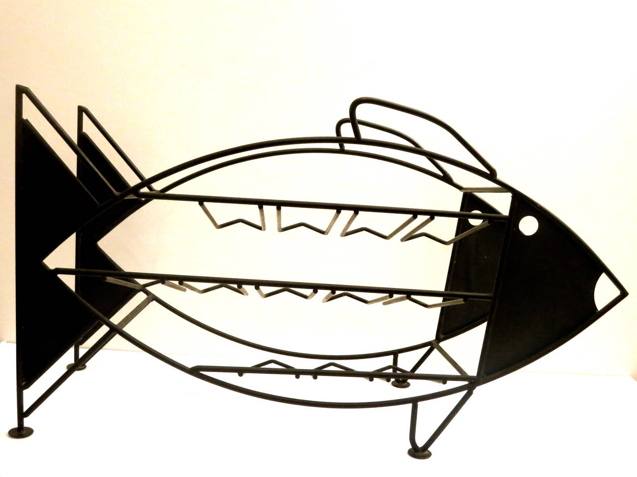 Whimsical fish sculpture wine rack, in solid iron pipping in black enameled finish, 12 bottle capacity, in its original finish sits in any counter top great and unique piece of conversation.