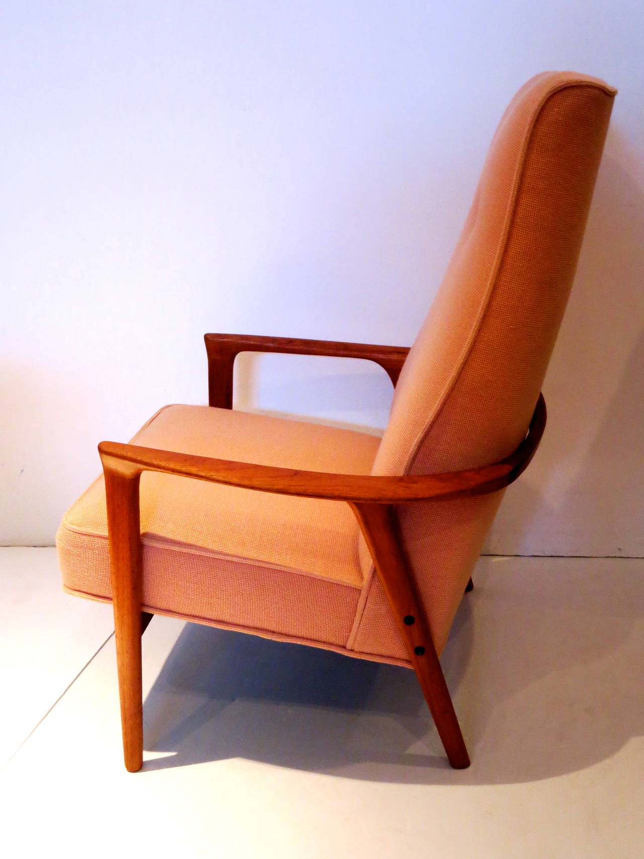 Beautiful solid teak armchair, tall back the base its refinished sand it and hand rubbed oil teak.The condition its great solid and sturdy and freshly recover in a peach cotton material, circa 1950s in great condition.