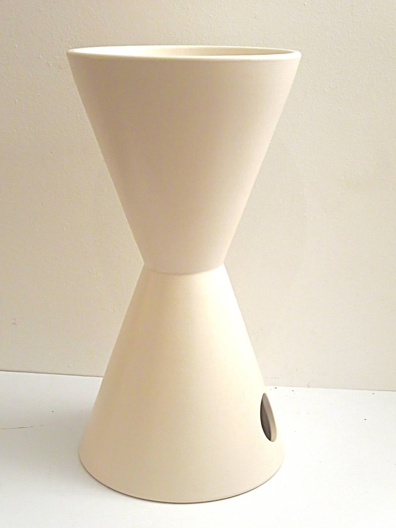 Simple lines on this tall  hour glass shape planter designed by Lagardo Tackett for Architectural Pottery Vessel model TH-2 in a cream white mate color finish great condition , no chips or cracks.