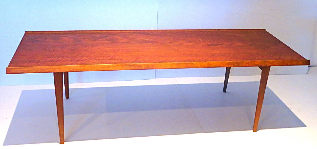 1950s striking coffe table , made in Denmark solid and sturdy freshly refinished beautiful grain, stamped at the bottom with raised edge sides .