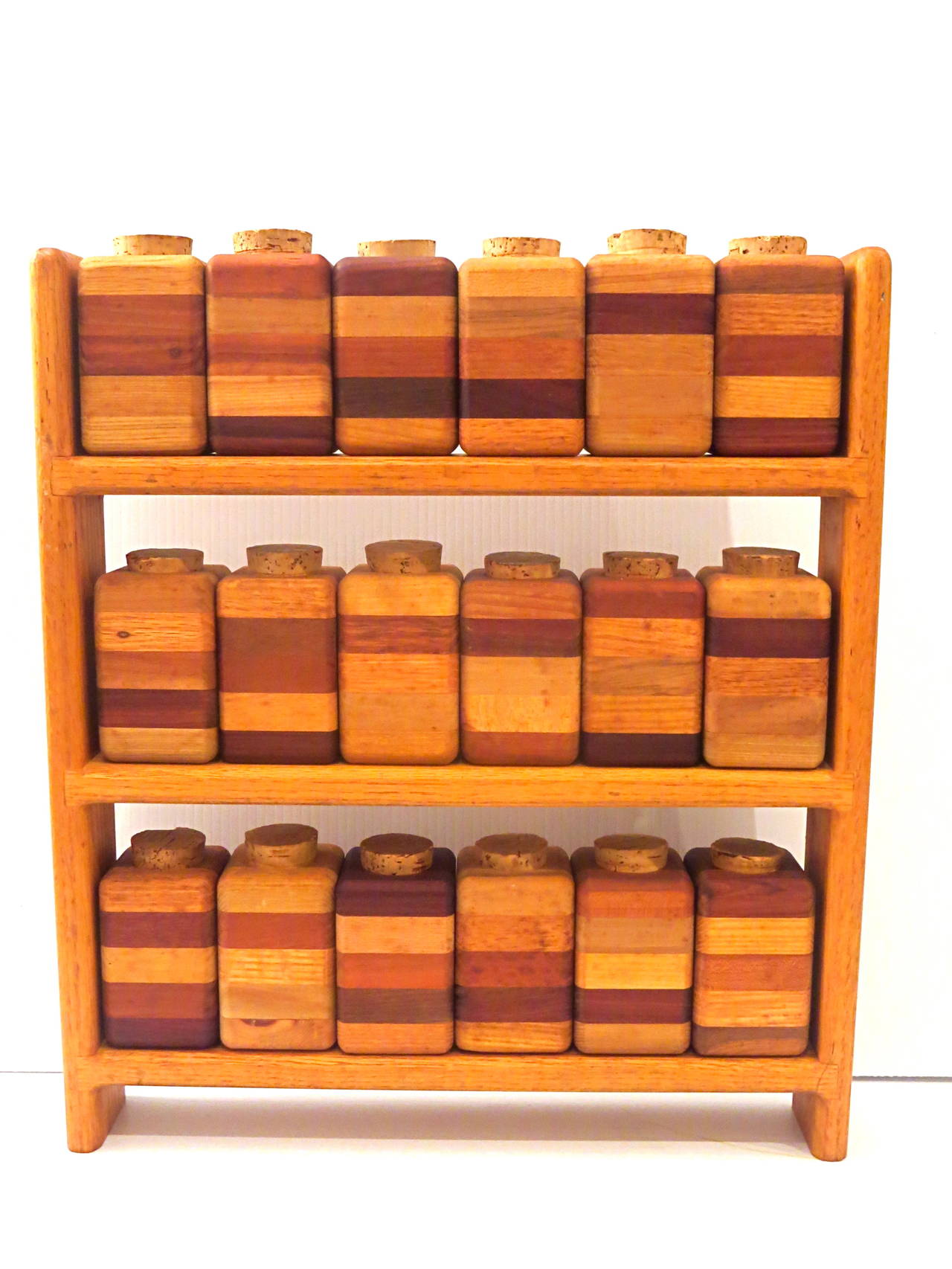 Incredible craftsmanship on this solid woods spice rack, circa 1960s, free standing or can be hung on the wall, each container has a cork top, one of a kind piece.