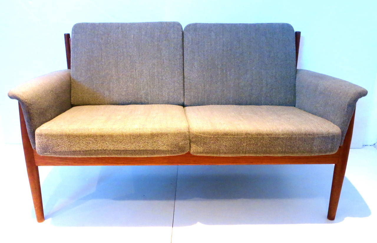 A very rare loveseat designed by Grete Jalk For France & Daverkosen, circa 1950s , a solid teak frame with recently upholstered cushions three years old from a non smoker home, with the original spring cushions and agrey cotton fabric very clean,