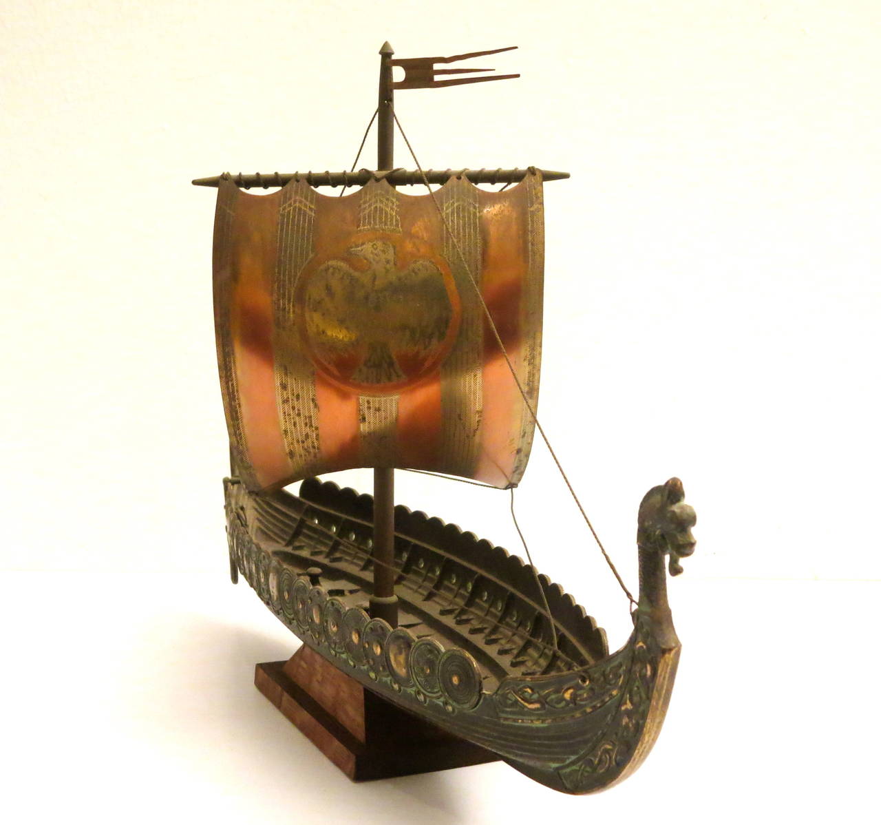 Collectible bronze cast , viking ship signed by Edward Aagaard , with copper & brass sail sitting on a solid teak base.made in Denmark circa 1970s.
