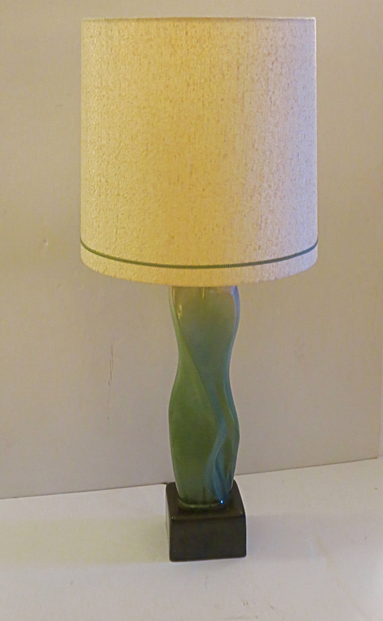 Striking tall nude female torso all one piece ceramic pottery , circa 1950s beautiful glaze , 3 way switch and milk glass shade , with its original lamp shade in good condition outside with some crackig on the inside plastic due to age , no chips or