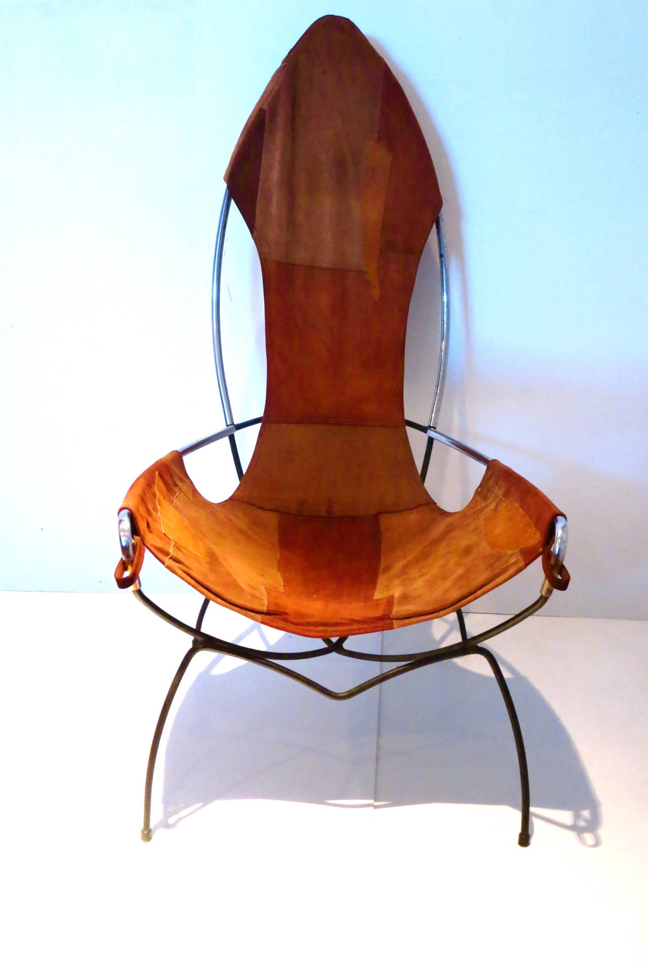 A unique single sling chair in chrome pipping , with solid iron combination , original patch work leather and ribeted , the chair its in its original condition circa 1970s, the chair its comfy and light very clean condition.