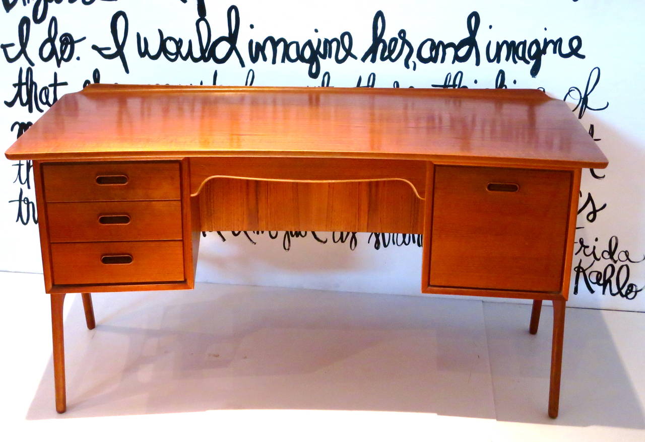 Icredible rare danish teak desk by Svend Aage Madsen for Sigurd Hansen , great condition very clean , all original circa 1950s Stamped , great quality with a front arched shape, and bookcaze, and file cabinet drawer.solid and sturdy.