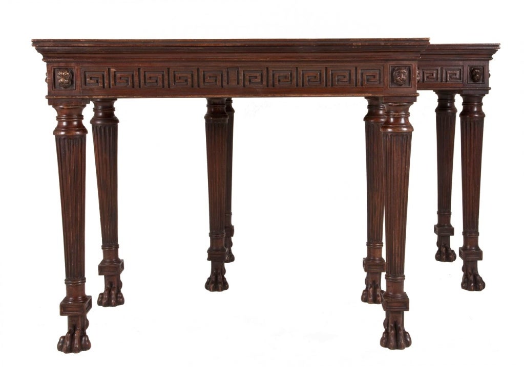 A Fabulous 19th C rare pair of Neoclassical Mahogany Pier Tables.
Mahogany tops surrounded by 'Greek Key' designed friezes, with lion head corner mounts. Tall slender finely reeded legs on carved lion paw feet.

If you would prefer a marble top