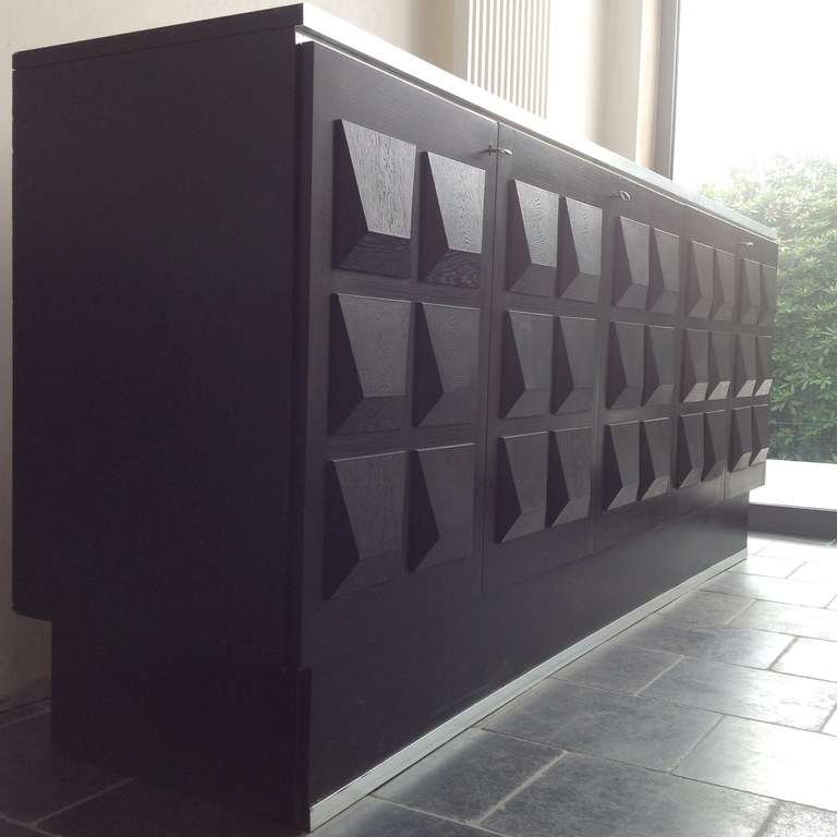 Very decorative graphic sideboard with black oak surface sculptural shapes and aluminium details.
The detailed pattern gives this sideboard it's unique expression.