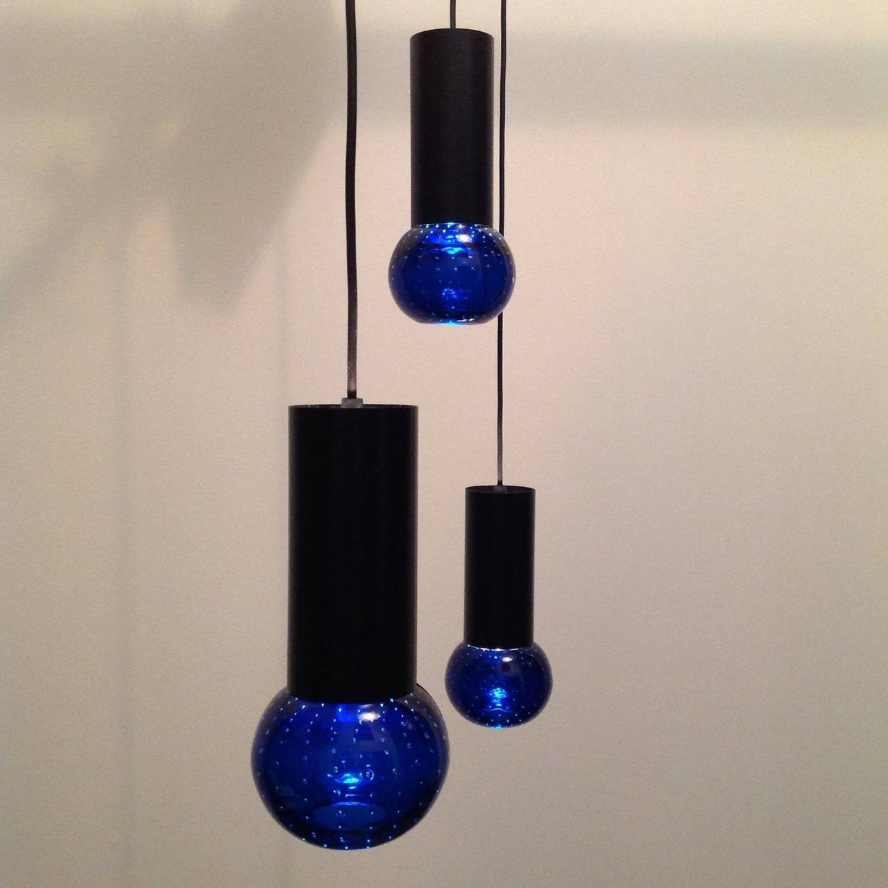 Three suspension or decoration lamps, beautiful deep blue color gives a very special light effect.
Made by Artiluce, glass part by Archimede Seguso, design Gino Sarfatti.

Pictures give a not so nice effect when lights are on, since the wattage