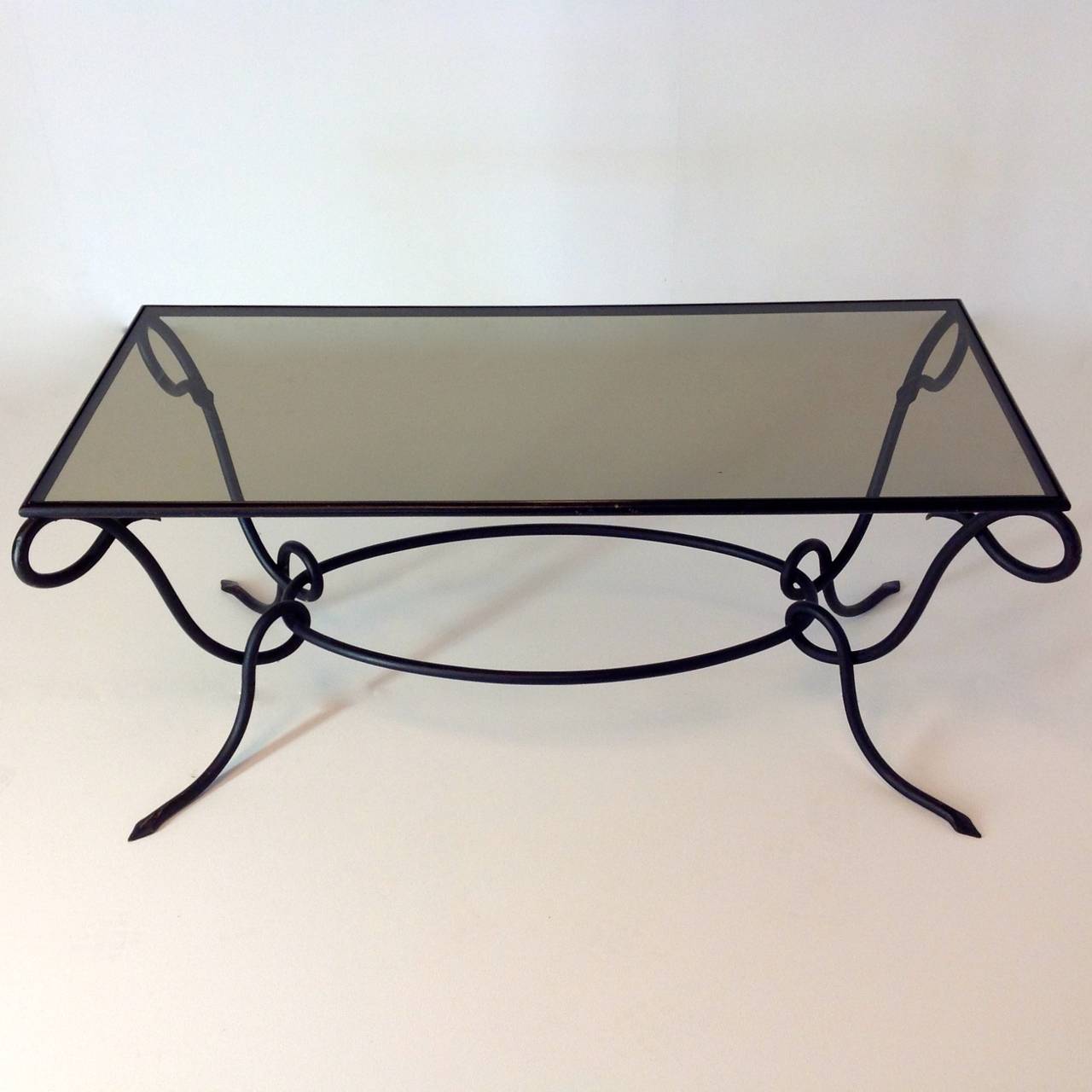 Rare and exceptional elegant coffee table design from 1940 by René Drouet
It's a model without rings and it appears that the table was repainted in black.
On some places the paint is gone, so he got just a beautiful patina.

More pictures and