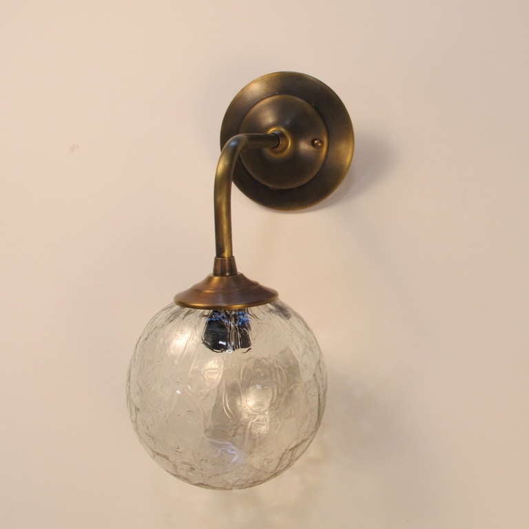 Sconce created with vintage glass globe. The frame is newly made and the glass globe is vintage. These are made to order. Lead time is 4-5 weeks. Single medium base socket up to 60 watts. UL approved. Courtesy to the trade. Finish shown is tarnished