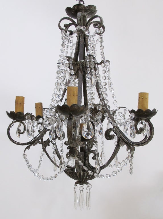 Antique Cut Crystal and Hand Forged Iron Chandelier, beautiful aged patina.

6 standard lights and one extra light in center of chandelier. standard base bulbs. New French Wiring done in U.S., 
UL Approved.

Courtesy to the Trade