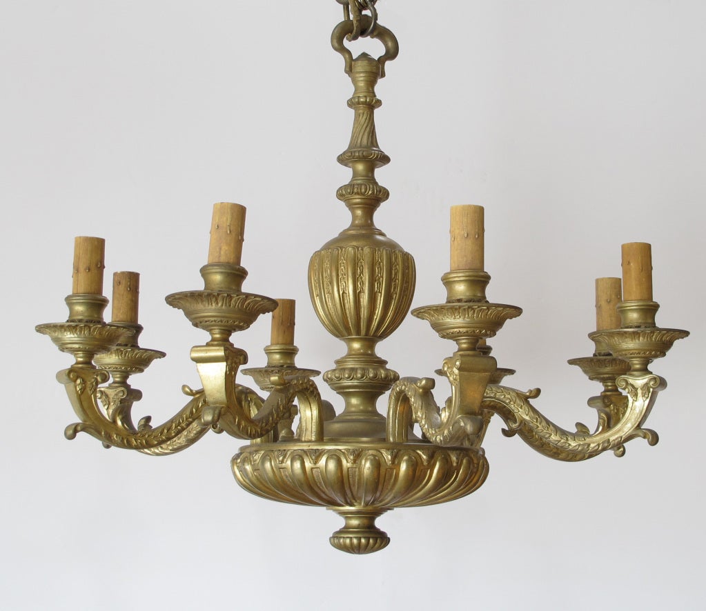 Antique French Regence 8 Light Gilt Bronze Chandelier. In Beautiful Condition. Heavy Bronze Chandelier, beautifully made. Stunning Patina. Stunning details. Great Chandelier for a Formal Dining Room or a Library. The size is perfect for many