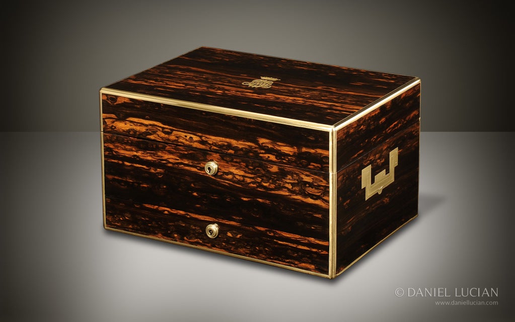 This 1895 Victorian Coromandel box was manufactured and retailed by one of England's most prestigious companies, Asprey. The exterior of the box is veneered in beautifully figured Coromandel, finely edged in brass, and finished with two elegant