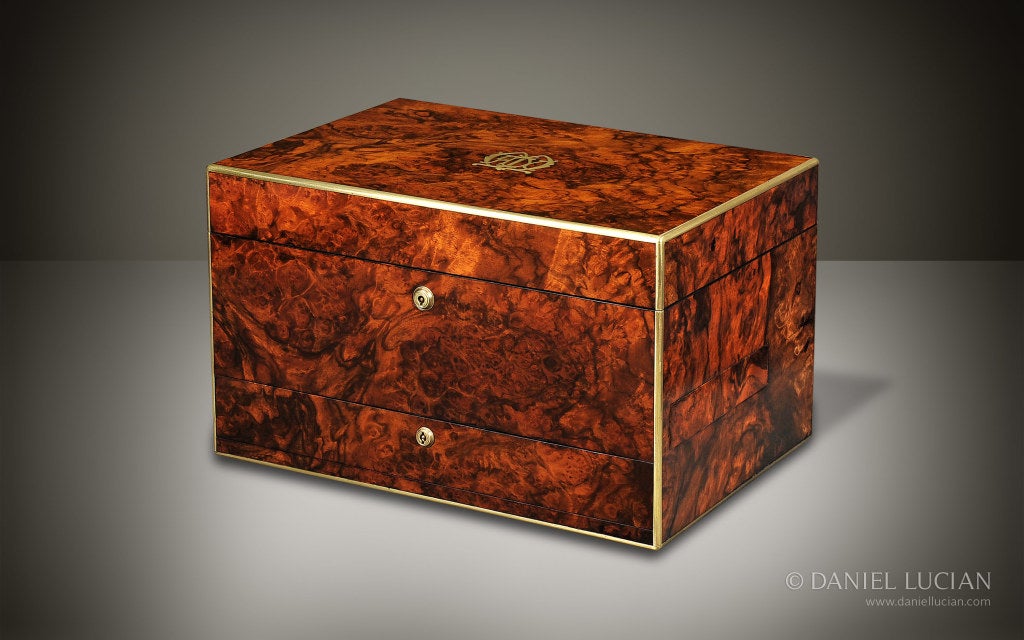 This large jewelry box is veneered in exquisite burr walnut wood. Burr walnut of this quality, and used to fashion a jewelry box of this size, is extremely rare to find.

The box features some lovely brass work: fine brass edging to the exterior;