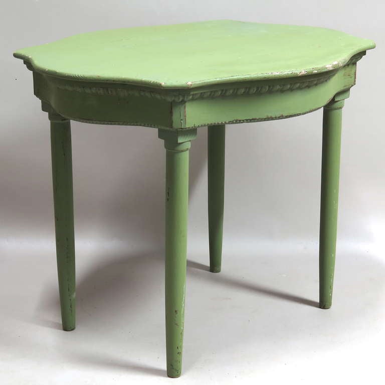 Charming center or side table with a serpentine shaped top and carved apron, painted a soft green.
