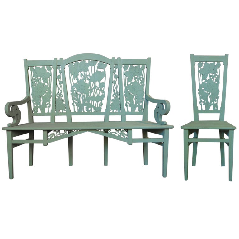 Wonderful set comprising ten chairs and a settee. All the pieces feature ornately cut-out and carved backs depicting large poppy plants and flowers, stylized in the flowing and elegant style that characterizes Art Nouveau. The seats of both the