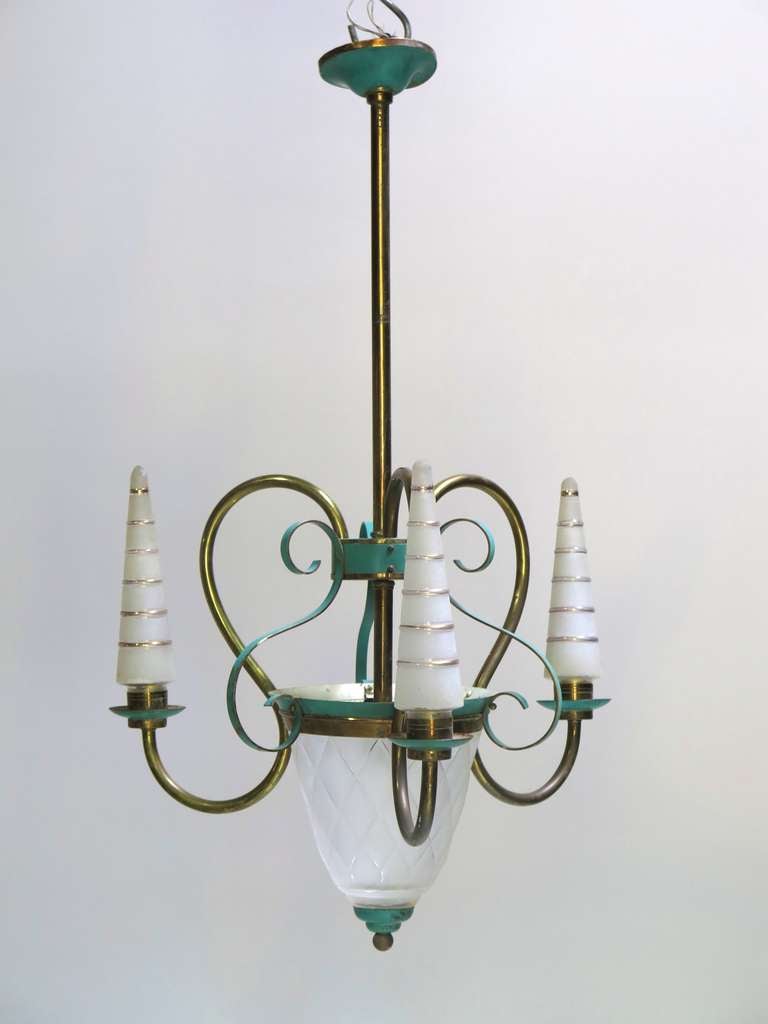 Elegant chandelier with three brass arms and central stem, green-painted tole, and frosted glass lights.