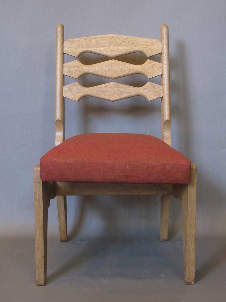 Four oak dining chairs by French design duo Guillerme & Chambron.

Great & unusual design, with cut-out pattern on backs and stretchers.

Wide & comfortable seats.

Very nice quality.

An extra 6 chairs are also available, exactly the same