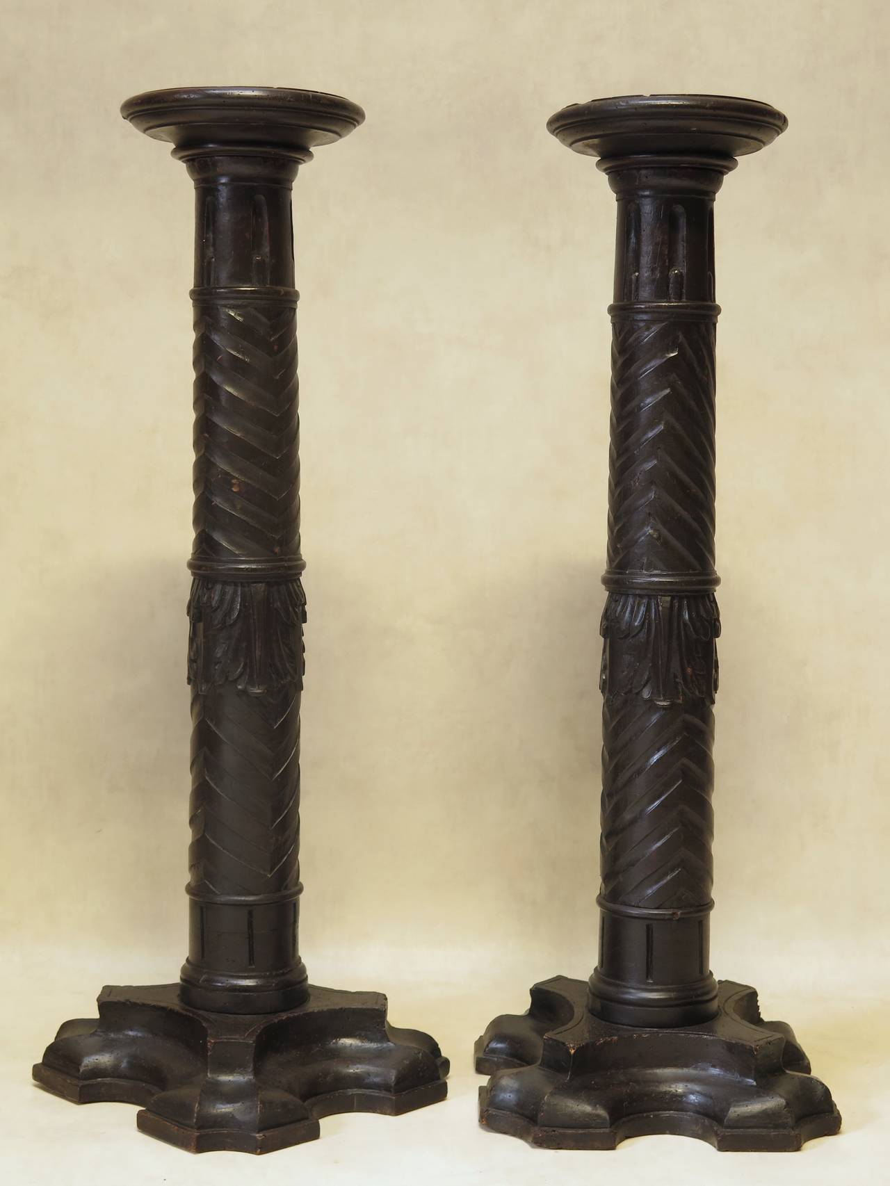 Wonderful pair of unusual antique hand-carved pedestals, with chevron motif and acanthus leaf detail mid-stem. Lovely bases.