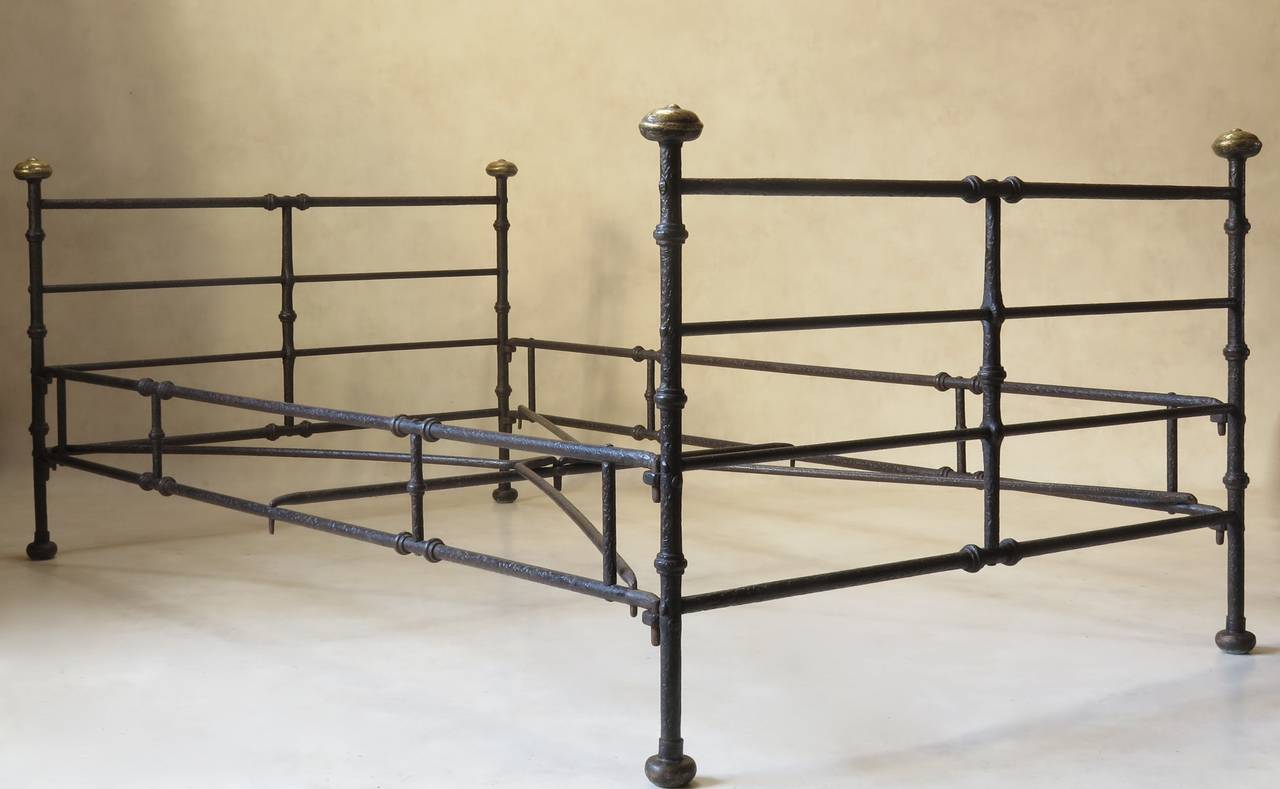 Wonderful textured iron bed with brass bed knobs. Comes apart.

Could also be used as seating/daybed.