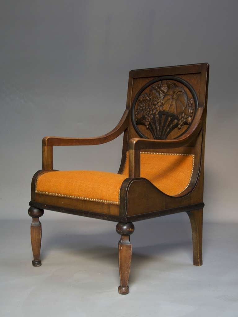 A unique and lovely set of unusual design, comprised of two chairs and two armchairs, with undulating seats covered in vintage ochre coloured fabric with a textured weave. Each back is adorned with a medallion containing a different carved fruit
