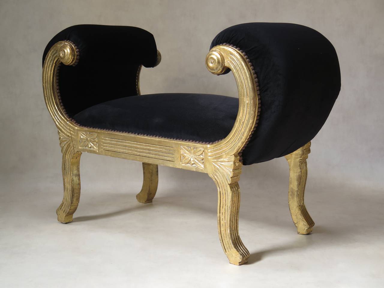 Fun and theatrical banquette with a gold-painted wood structure and scrolled arms.