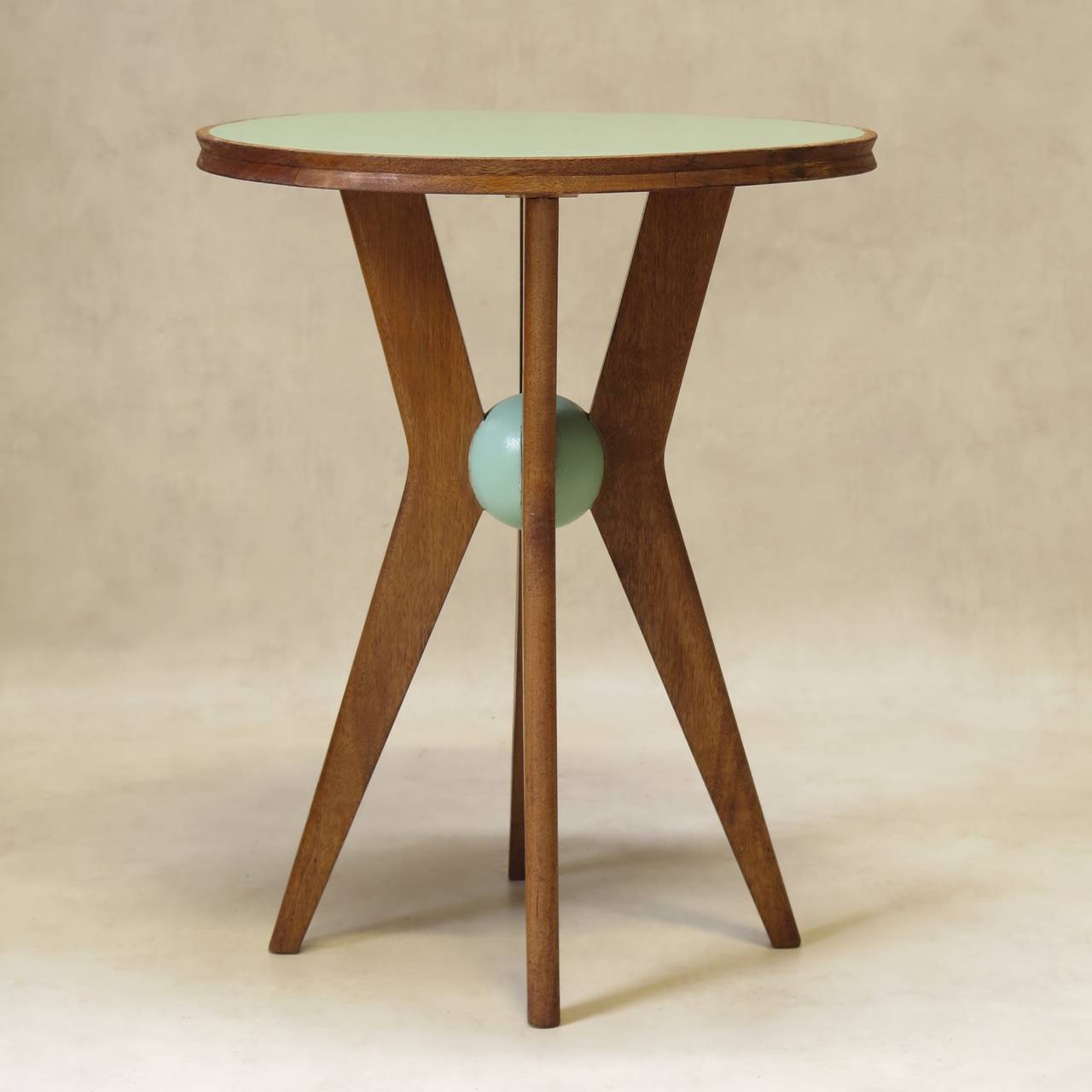 Fantastic pair of oak side tables with X-shaped bases, joined in the center by a light green sphere. The table top is also painted light green.

Very well made. Beautiful detail, and great design.