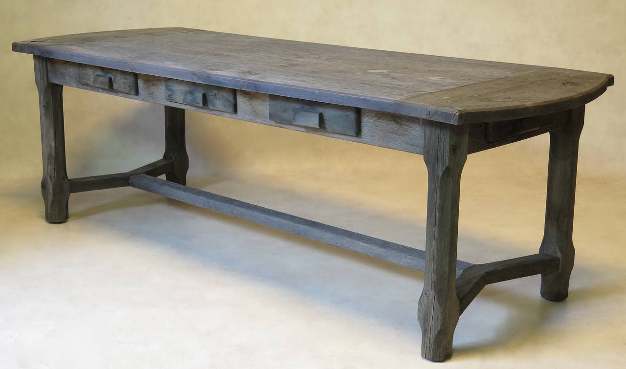 Charming rustic country-style dining table, in solid oak with a lovely weathered patina. The table top has rounded ends. Eight drawers (three along each side and one at each end).

Seats eight to ten people.